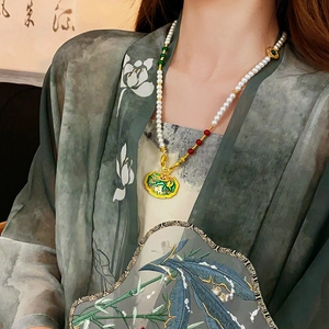 Detail of pearl necklace with gold Ruyi lock pendant and enamel lotus fan details