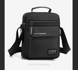 Detailed close-up of a men's black nylon shoulder bag with zipper and buckle details