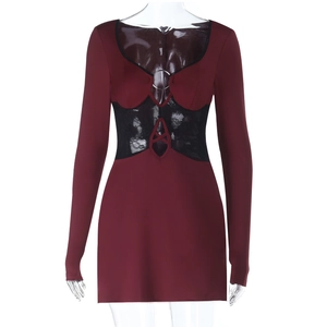 Close-up of wine red lace stitching with central metal ring on slim-fit long sleeve dress