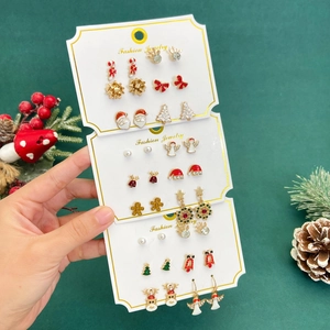 Christmas earring set with Santa Claus and Reindeer designs on card display