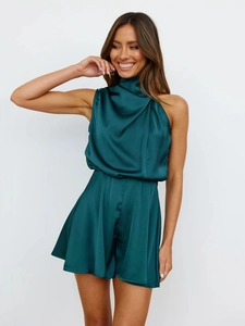 Detail of the elegant cowl neck and dark green satin texture on a sleeveless romper