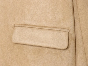 Close-up of camel suede jacket showing high-quality pocket detail and fine texture