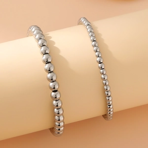 Braccialetti a sfere in acciaio inossidabile argento lucido su espositore cilindrico