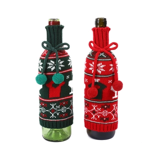 Christmas knitted wine bottle covers with snowflakes and pom-poms in red and green