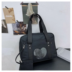Detailed view of black Oxford travel bag with heart window and small coin pouch