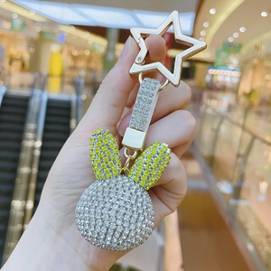 Glittering rabbit keychain with silver and green crystals on a gold star clasp