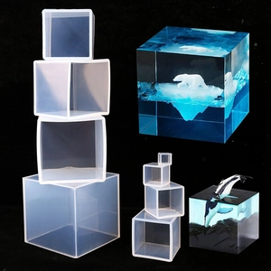 Macro detail of cube silicone molds and clear resin specimens with arctic animal models