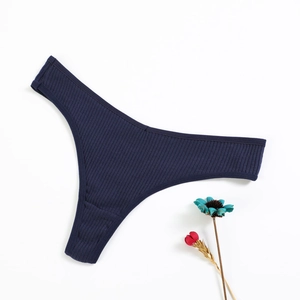 Navy blue ribbed cotton thong for women on white background with decorative flowers