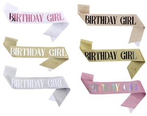 Close-up of Birthday Girl satin sashes in six glitter colors with gold pins included