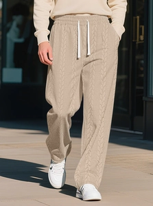 Close-up of cable knit texture on beige men's lounge pants with white drawstring detail