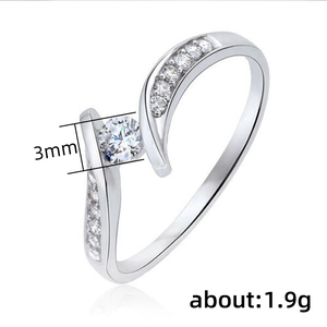 Macro detail of 3mm round moissanite on a wave-shaped silver ring weighing about 1.9g