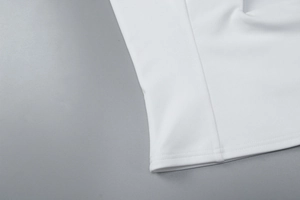 Detailed close-up of double stitching and smooth white fabric on sleeveless halter top