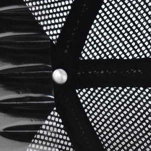 Detail of black mesh truck cap showing breathable fabric and silver metal rivet reinforcement