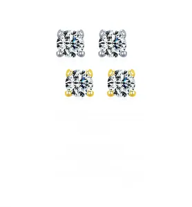 Close-up of classic round moissanite stud earrings in silver and gold claw settings