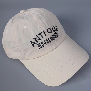 Close-up of Antique embroidery on beige quick-dry nylon baseball cap with curved brim