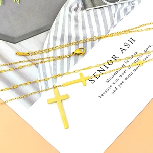 Detailed view of 18K gold-plated double cross necklace with lobster clasp and extension chain