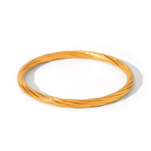 Macro detail of a classic hollow texture stainless steel twisted rope bangle in gold