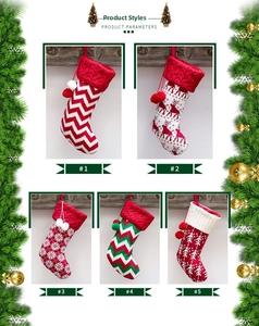 Detail view of five knitted Christmas stockings with elk patterns and hanging pom-poms