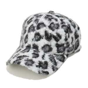 Close-up of fluffy black and white leopard print baseball cap in plush faux shearling fabric