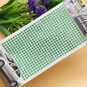 Macro shot of self-adhesive green 3mm acrylic rhinestone stickers for DIY car decor