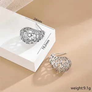 Irregular hollow metal drop earrings in silver finish with intricate heart patterns