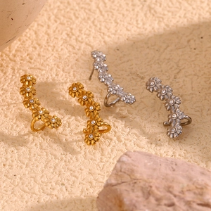 Detail of five-flower gold and silver ear cuffs with clear cubic zirconia inlay