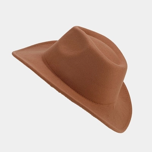 Detail of caramel wool fedora hat showing refined felt texture and wide brim finish