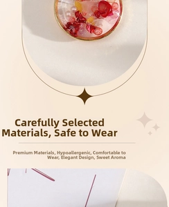 Detail of alloy pendant featuring red dried flower petals and mini pearls in resin