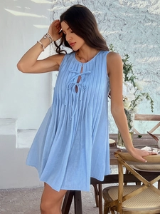 Detail of blue sleeveless pleated mini dress featuring a front tie-up design for women
