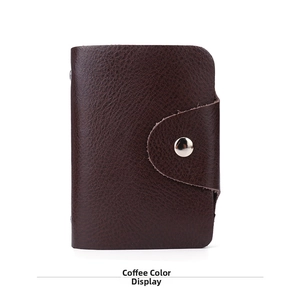 Macro detail of dark coffee genuine leather card holder with lychee texture and silver snap