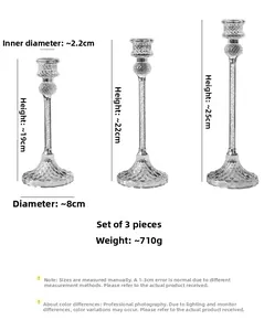 Detail view of clear glass candle holders set in three heights: 19cm, 22cm and 25cm