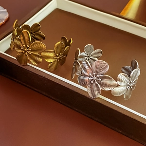 Detail of vintage gold and silver flower bangles with antique finish inside a jewelry box