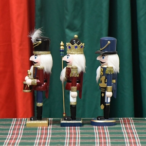 Three 25cm pearlescent pink nutcracker figurines in king, drummer and soldier styles