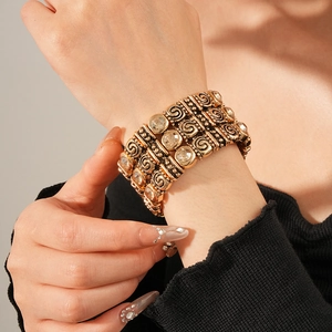 Detail of vintage gold-plated wide link bracelet with crystal inlay and spiral relief