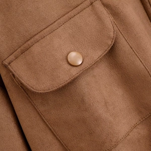 Close-up of suede jacket pocket with reinforced stitching and matching resin button