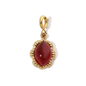 Detailed view of teardrop crimson gemstone pendant with vintage gold stainless steel frame