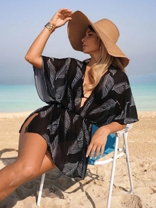 Elegant black floral print beach cover-up with white leaf patterns for a resort look