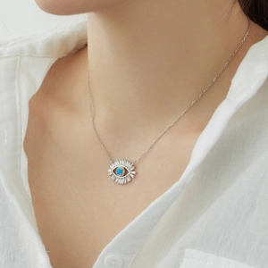 Close-up of S925 sterling silver eye pendant with blue gemstone and clear zircons