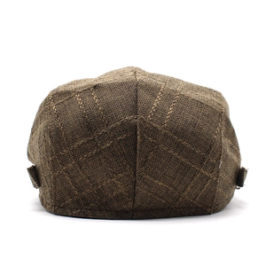 Close-up detail of dark brown plaid texture and stitching on cotton linen flat cap