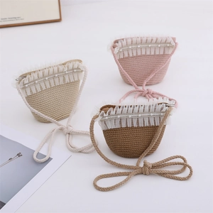 Detail of woven straw crossbody bags with lace trim, pearl accents, and zip closure