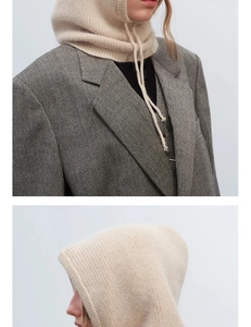 Close-up of cream knit balaclava hood texture with grey tweed blazer styling
