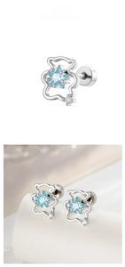 Macro detail of bear-shaped stud earrings featuring blue star zircon and S925 silver