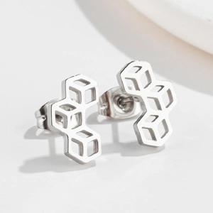 Close-up of geometric hollow square stud earrings in silver polished stainless steel