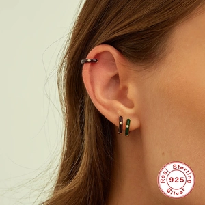 Detail of 925 sterling silver hoop earrings set with enamel and sparkling zircons