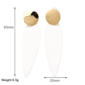 Detail shot of long white leaf earrings with gold studs and 83mm length dimension