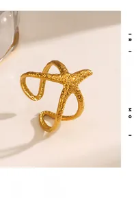 Detailed view of golden starfish ring with hammered texture and adjustable open band