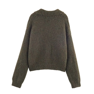 Close-up of the fuzzy texture and ribbed crew neck on this dark brown knit sweater