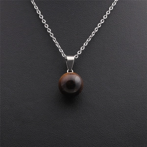 Minimalist silver chain necklace featuring a polished round tiger eye stone pendant