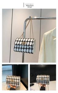 Detail of white and black tweed crossbody bag with gold chain and metal lock