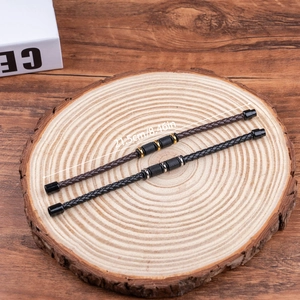 Macro view of woven leather bracelets in black and brown with magnetic clasp and 21.5cm length